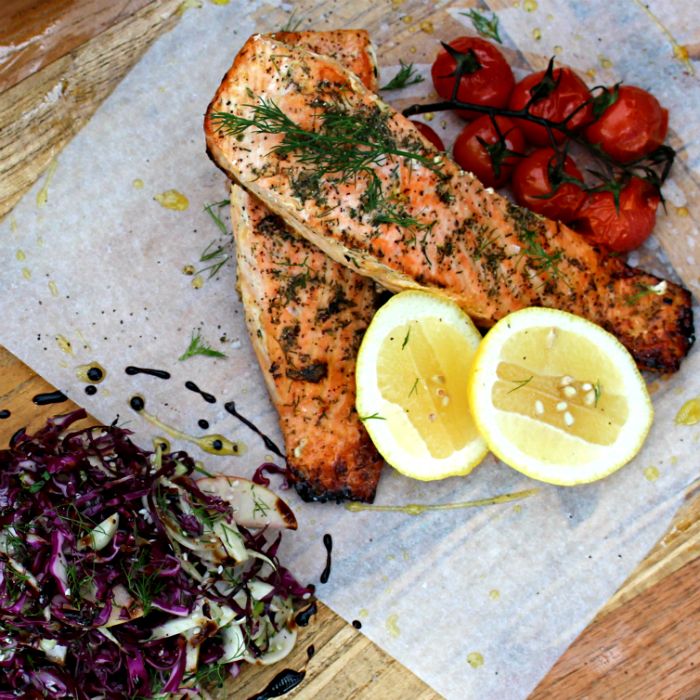 Refined salmon dish with greens and lemon